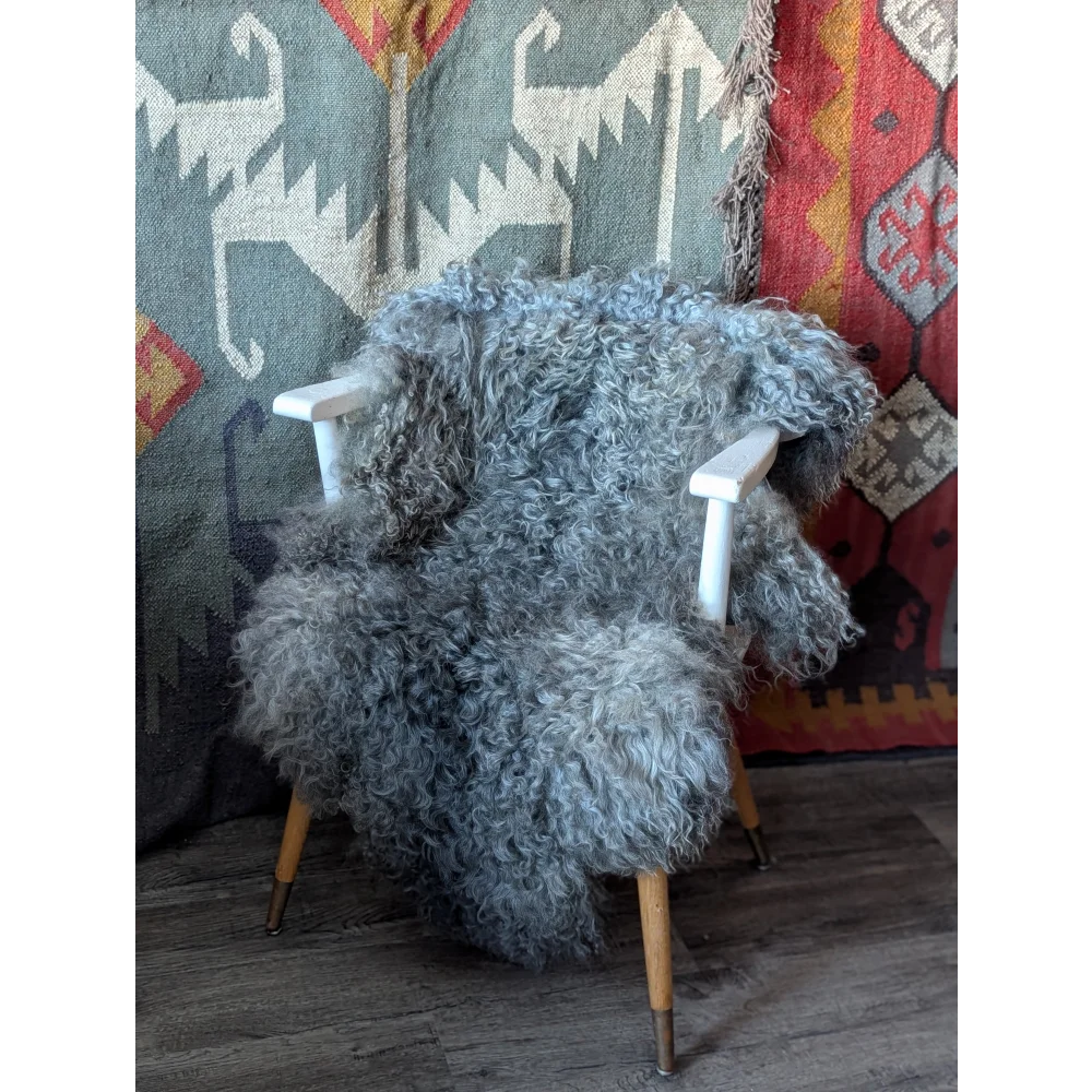 Cozy 50x31 Gotland sheepskin rug draped on white wooden chair