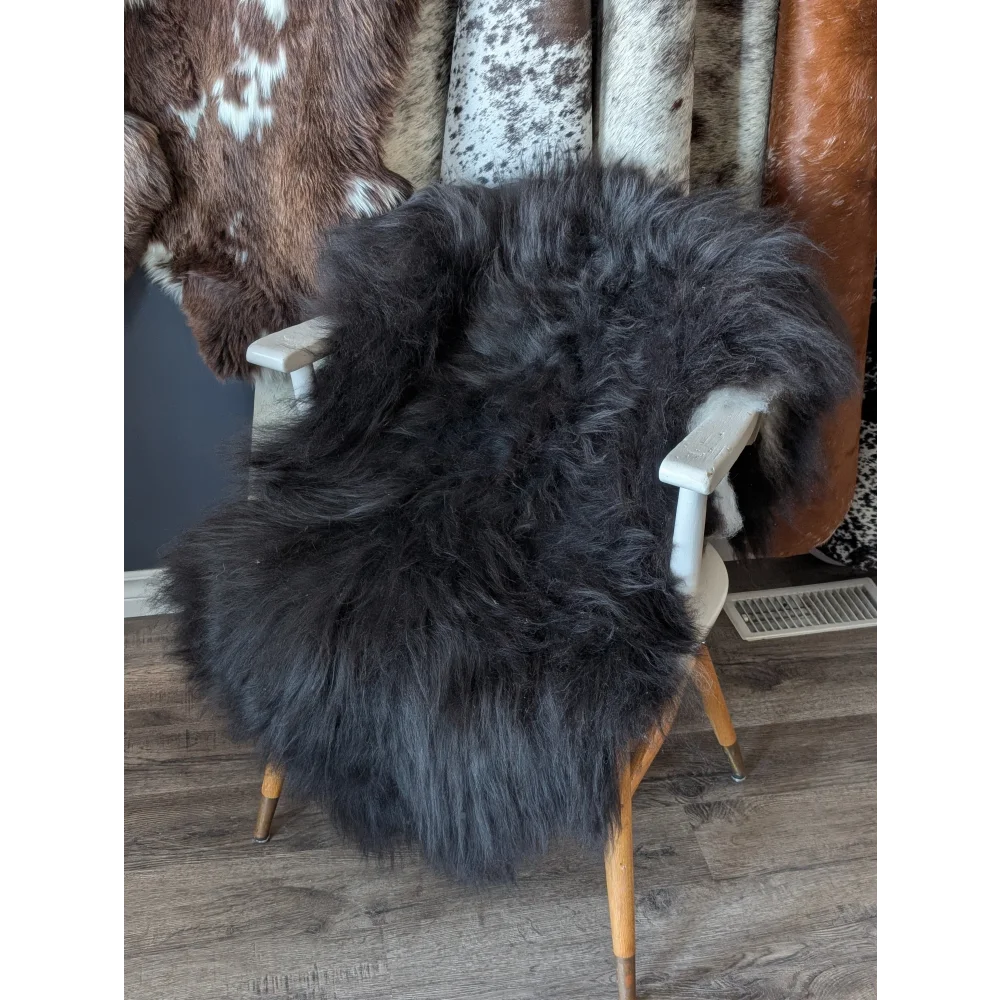 Soft Icelandic sheepskin rug on white wooden chair, 50x28 inches