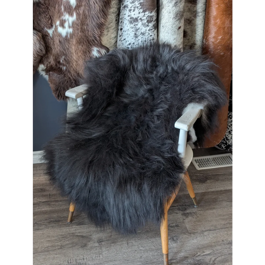 Soft Icelandic sheepskin rug on white wooden chair, 50x28 inches