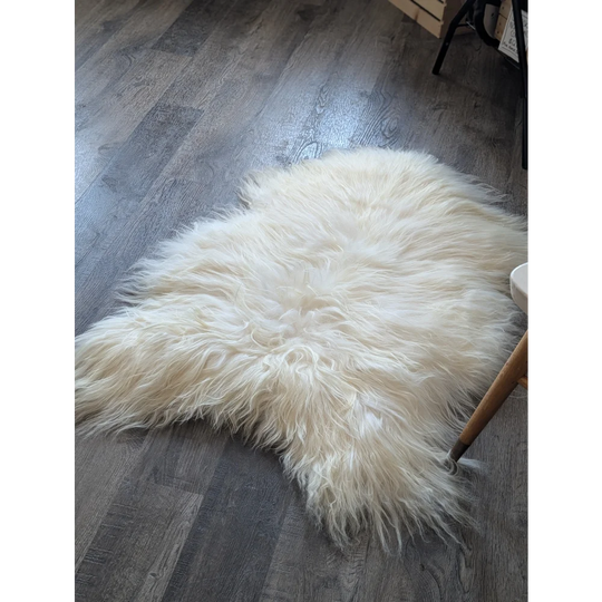 Soft Icelandic sheepskin rug 50x34 inches on dark wood floor