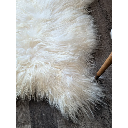 Soft Icelandic sheepskin rug 50x34 inches on dark wood floor