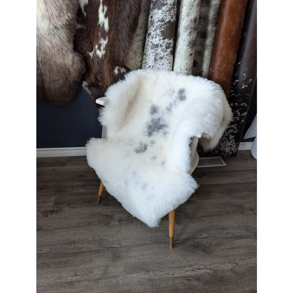 Soft Icelandic sheepskin rug 49x33in with gray speckles on chair