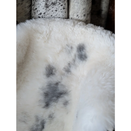 Soft Icelandic sheepskin rug 49x33in with fluffy texture and gray paw prints