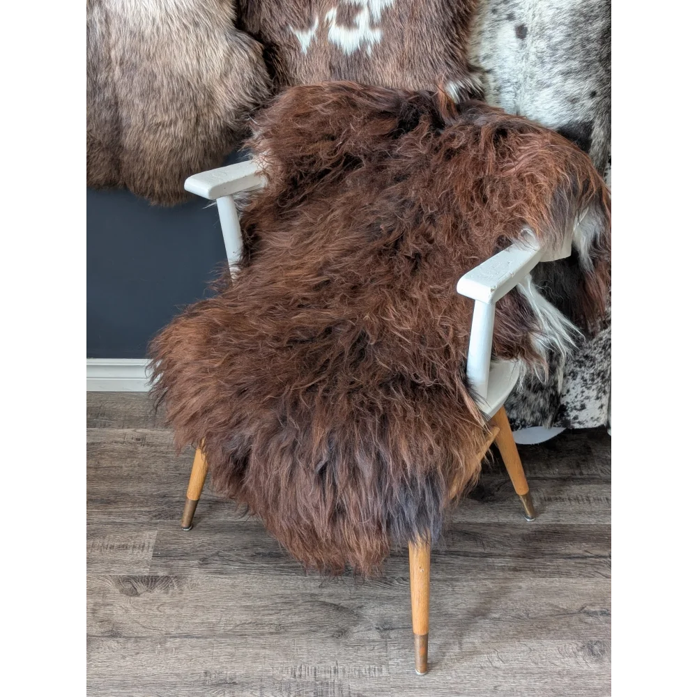 Soft Icelandic sheepskin rug 51x29in draped on white wooden chair