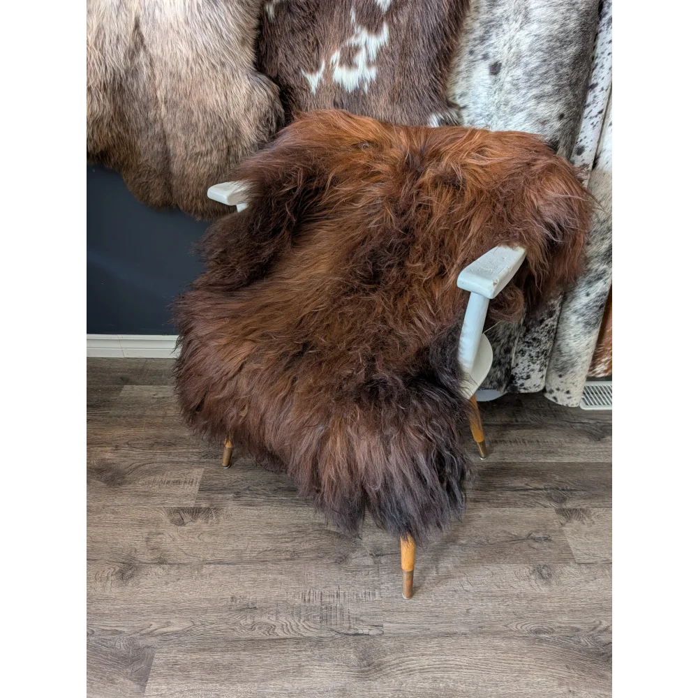 Soft Icelandic sheepskin rug 47x31in on white chair