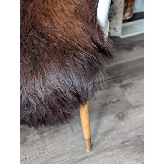 Plush dark brown Icelandic sheepskin rug chair, soft faux fur with wood legs