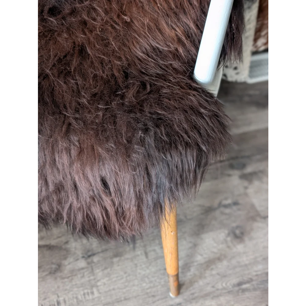 Plush dark brown Icelandic sheepskin chair with wooden legs, 48x30 inches