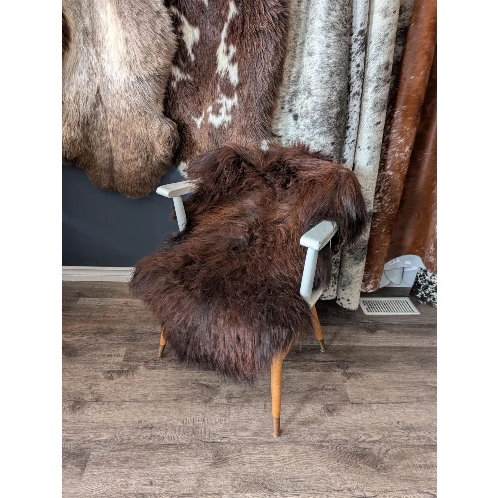Soft Icelandic sheepskin rug on white wooden armchair, 48x30 inches