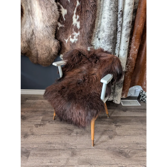 Soft Icelandic sheepskin rug on white wooden armchair, 48x30 inches