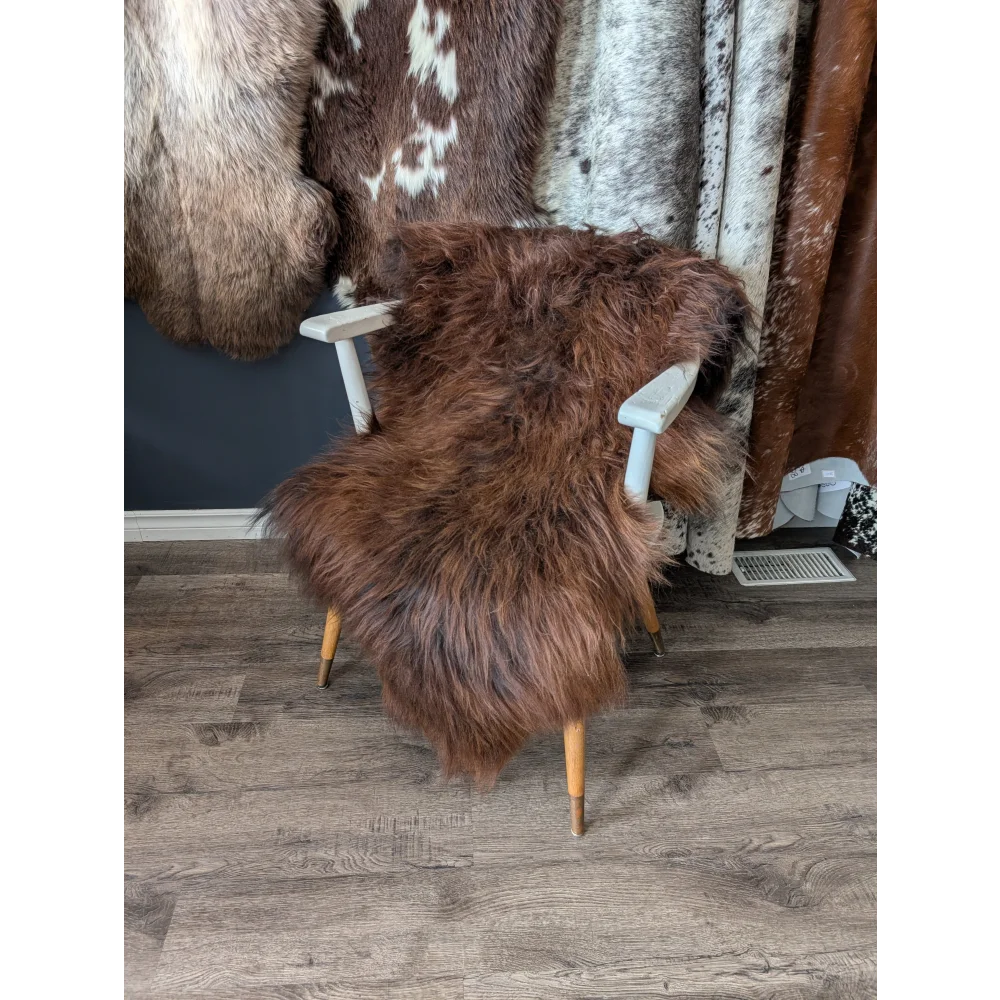 Soft Icelandic sheepskin rug on white wooden chair