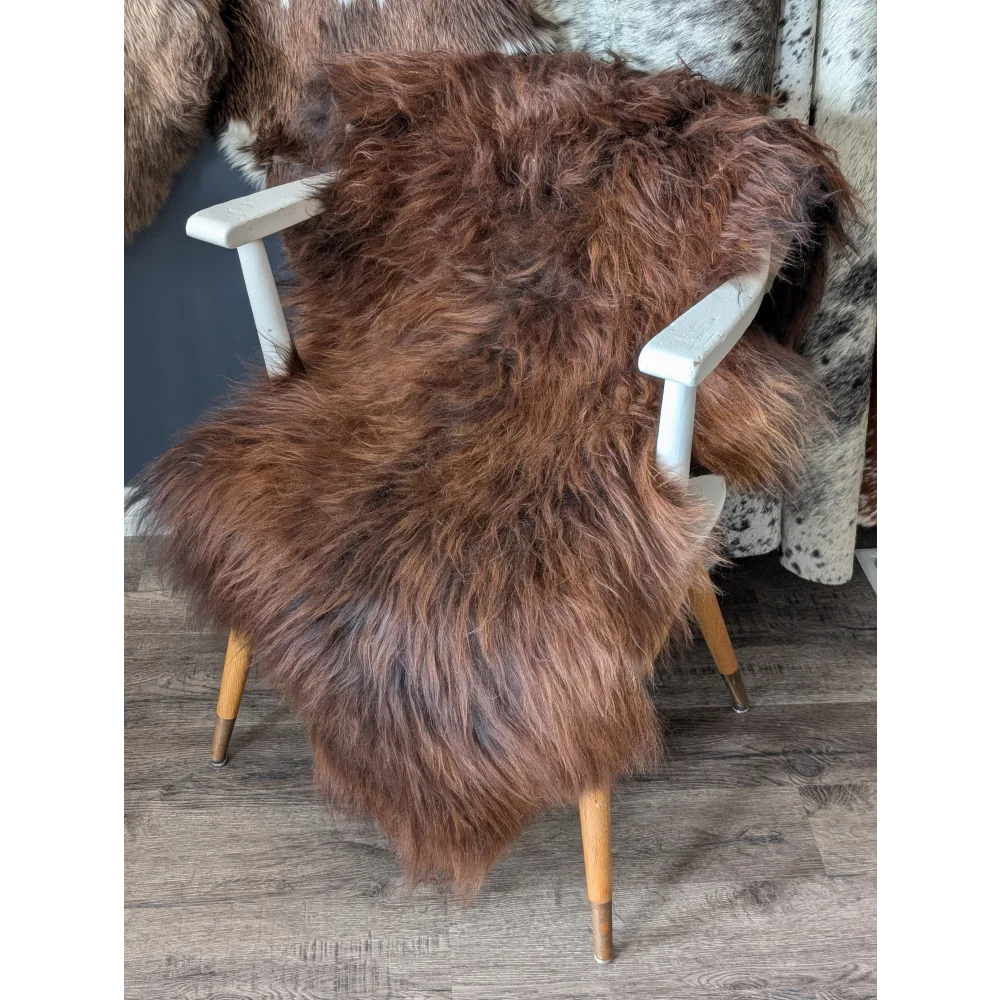 Soft Icelandic sheepskin rug on white wooden chair
