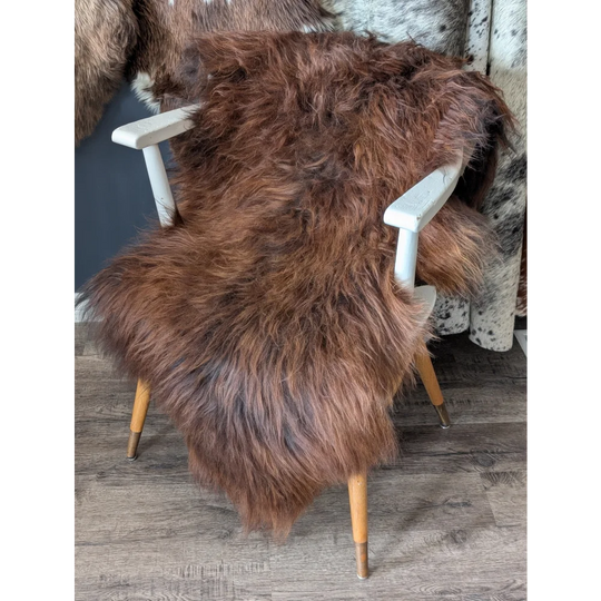 Soft Icelandic sheepskin rug on white wooden chair