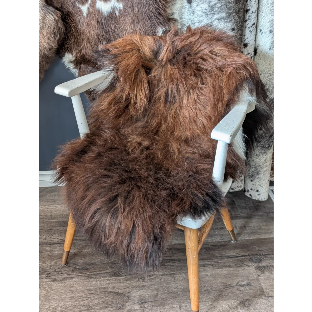 Soft Icelandic sheepskin rug draped over white wooden chair