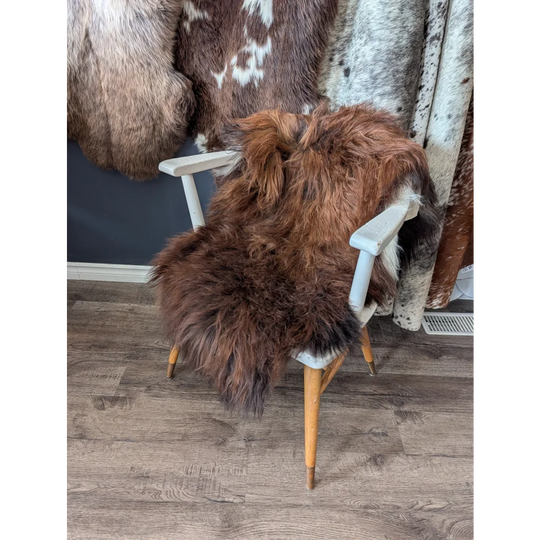 Soft Icelandic sheepskin rug draped over white wooden chair