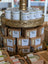Golden tiered stand with lanolin soap bars in glass jars and kraft packaging