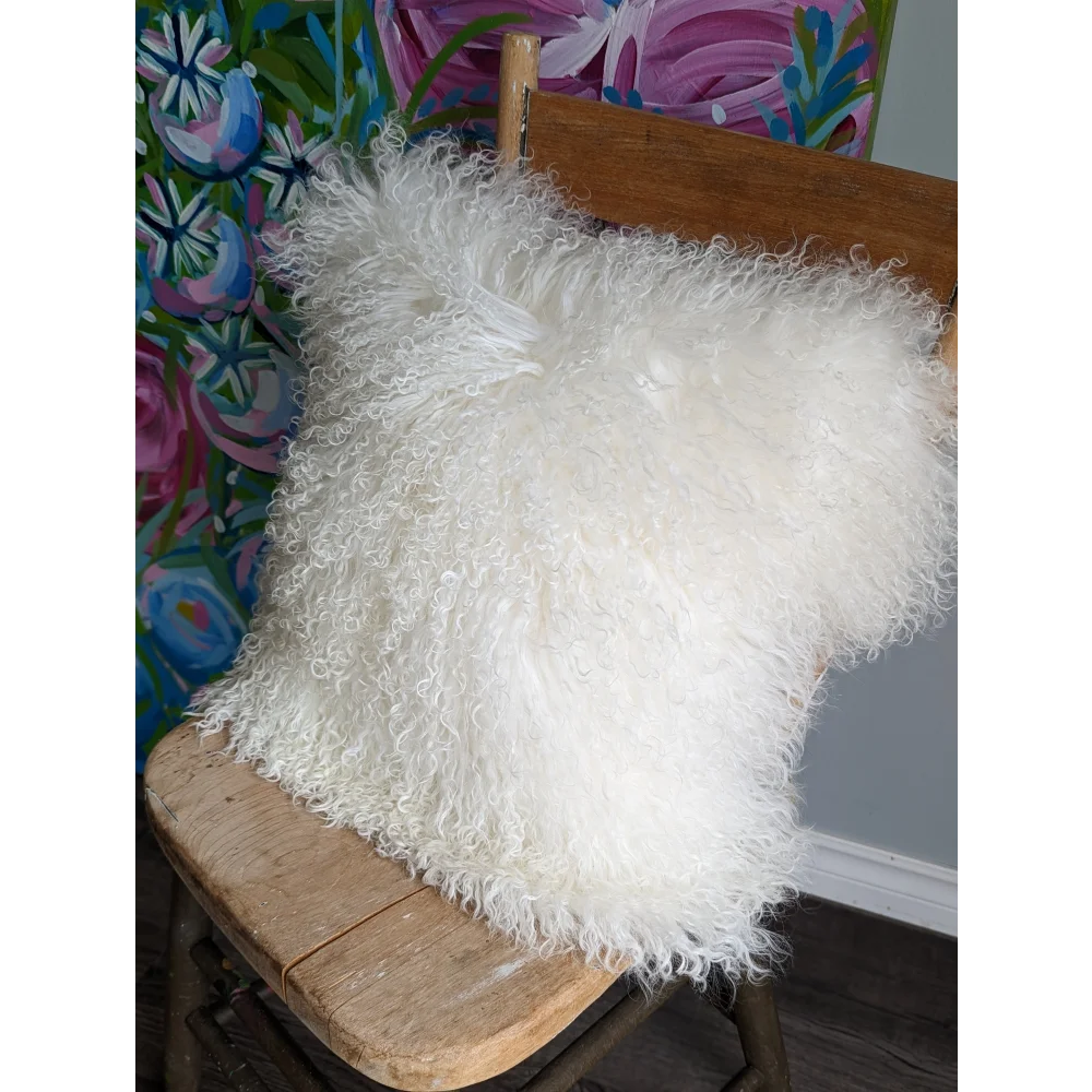 White fluffy Mongolian sheepskin cushion with textured faux fur surface