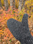 A dark gray knitted azalea mitten with a ribbed pattern made from soft zealand wool no floral embroidery visible