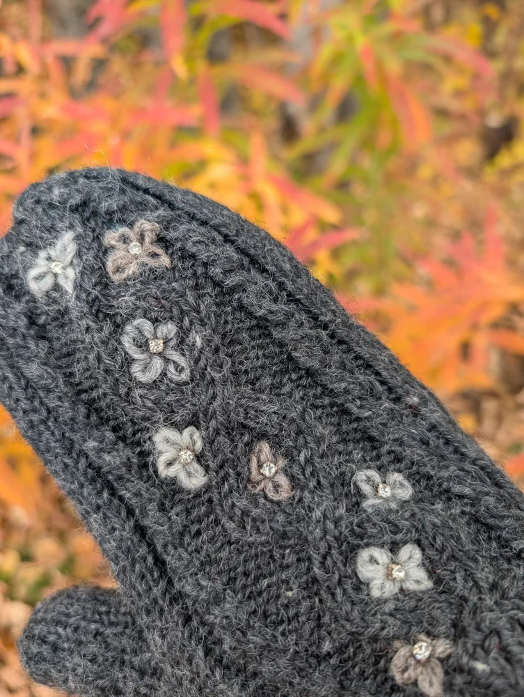 Dark gray azalea mittens with floral embroidery in light gray and beige on zealand wool knit glove back side