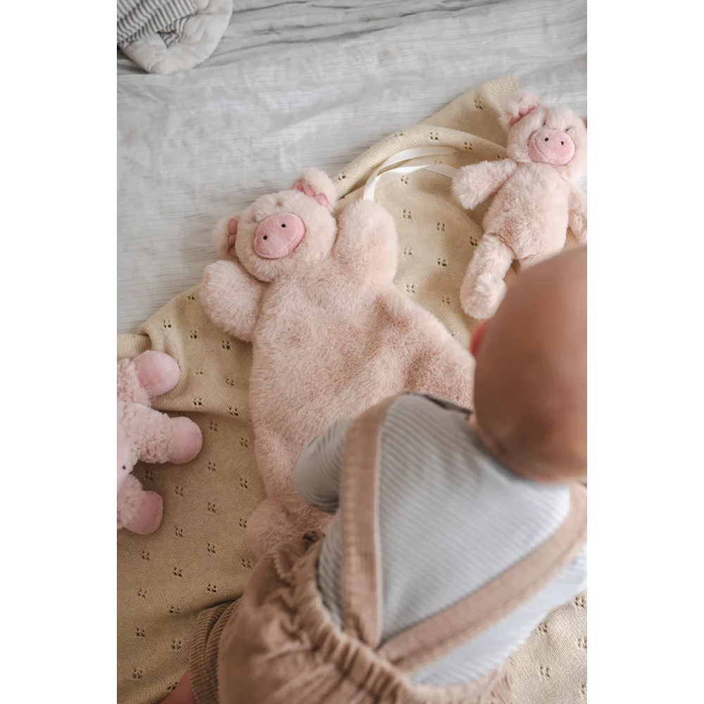 Baby’s head and shoulder in soft clothing from Baby Gift Set ❤️ with medical sheepskin