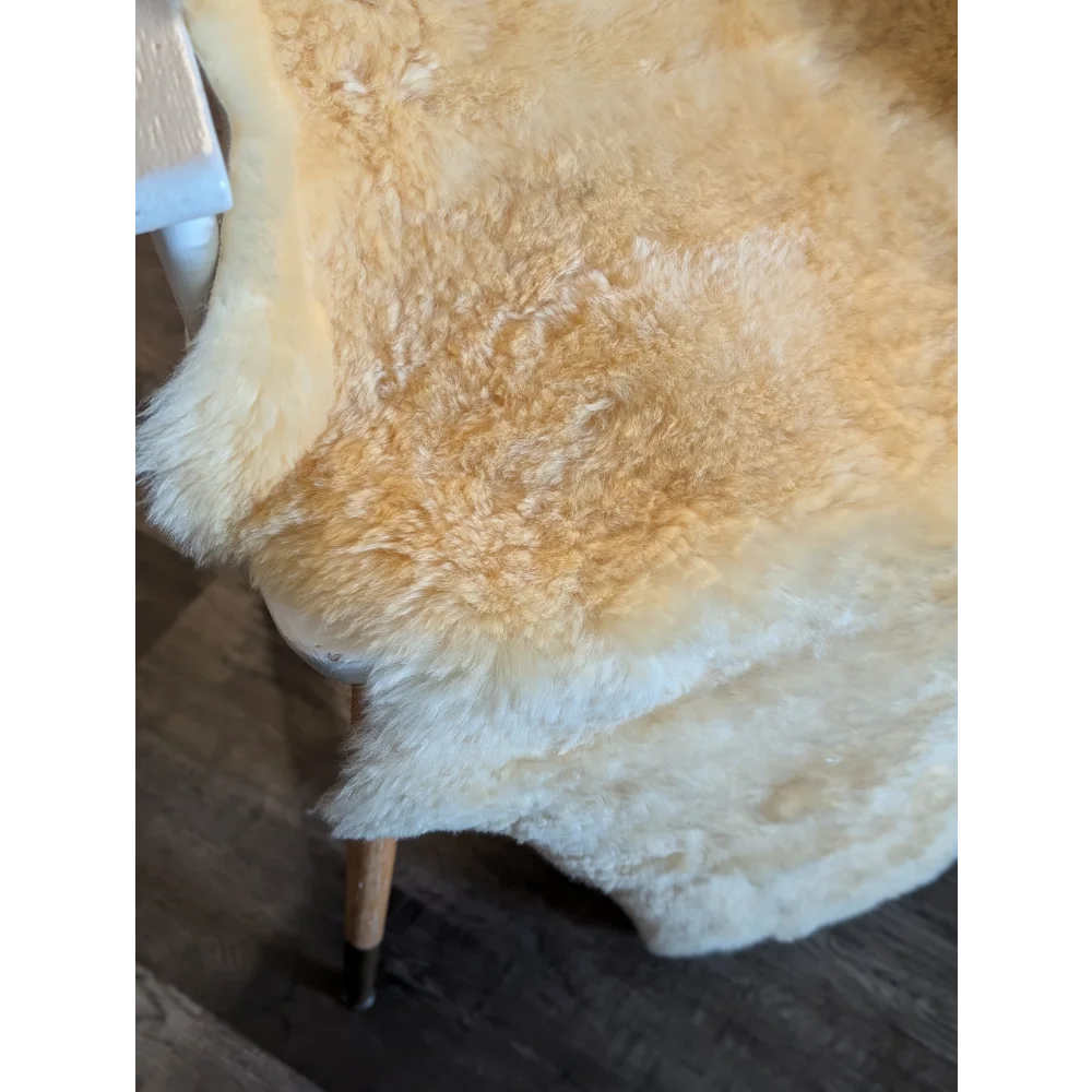 Cream-colored fluffy medical sheepskin rug with natural texture and irregular edges by angus oliver canada