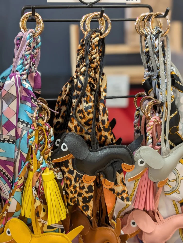 Black dachshund bag charm with orange accents and leopard scarf