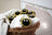 Yellow and black fuzzy bee trio eco wool dryer balls nestled in a wicker basket with white towels