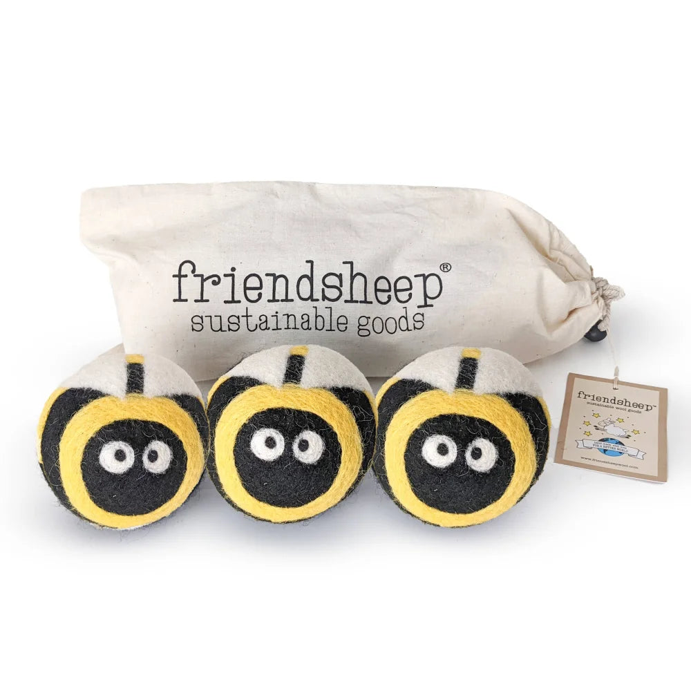 Three fuzzy yellow and black eco dryer balls shaped like bees with embroidered eyes bee trio set of 3