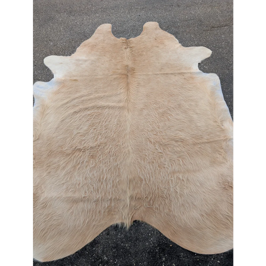 Beige extra large cowhide rug with natural tan and white markings and leather texture
