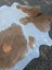 Beigewhite 117 large cowhide rug with brown and white natural edges offering rustic charm and beautiful rugs look