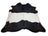 Large black and white cowhide rug with natural irregular edge featuring unique characteristics for beautiful rugs