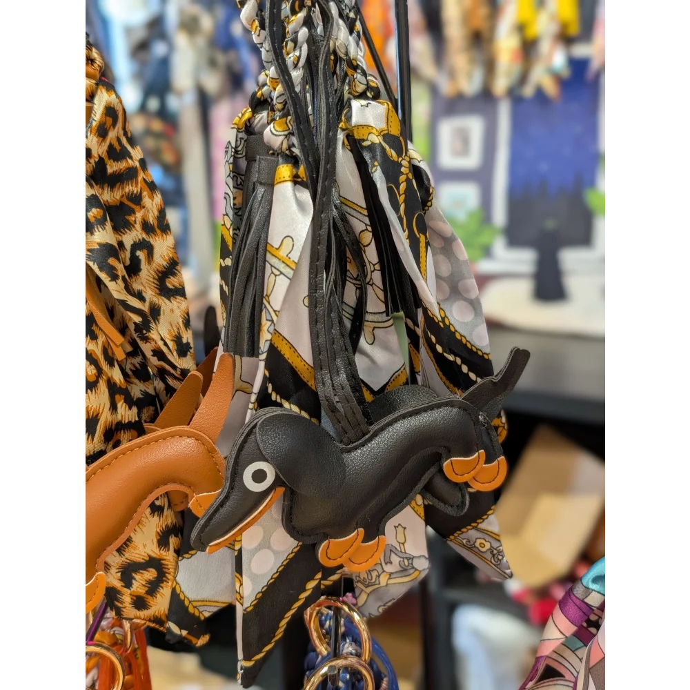 Black dachshund bag charm in real leather with orange accents