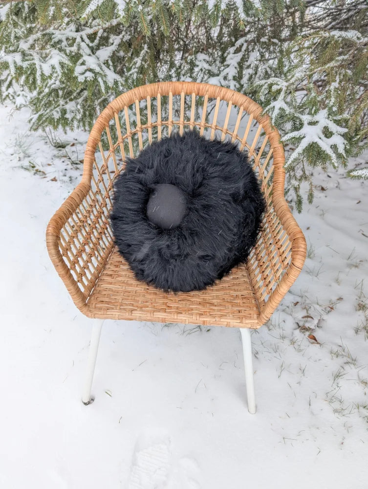Black rotund sheepskin cushion with black faux fur and smooth dark center accent perfect for rotund sheep cushions