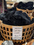 Black sheepskin seat belt covers by Angus Oliver in woven basket with price tag