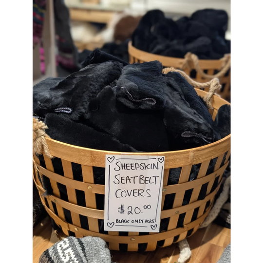 Black sheepskin seat belt covers by Angus Oliver in woven basket with price tag