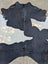 Large black and white cowhide rug 85.5 by 77 inches with natural fur texture and unique rustic charm