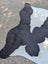 Black and white large cowhide rug with natural fur texture and unique characteristics for rustic charm spaces