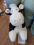 A plush black white cow toy with soft fluffy fur and a giant snuggly muzzle perfect for cuddling