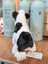 A plush black white cow toy featuring a giant snuggly muzzle and a fluffy tail perfect for cuddling