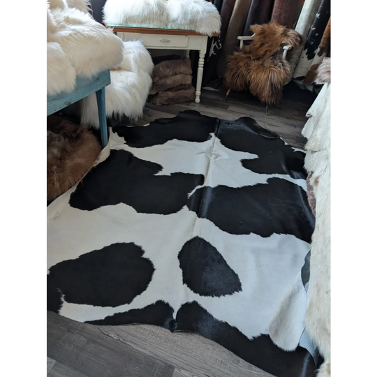 Large cowhide rug with black and white natural irregular patches from angus oliver beautiful rugs collection