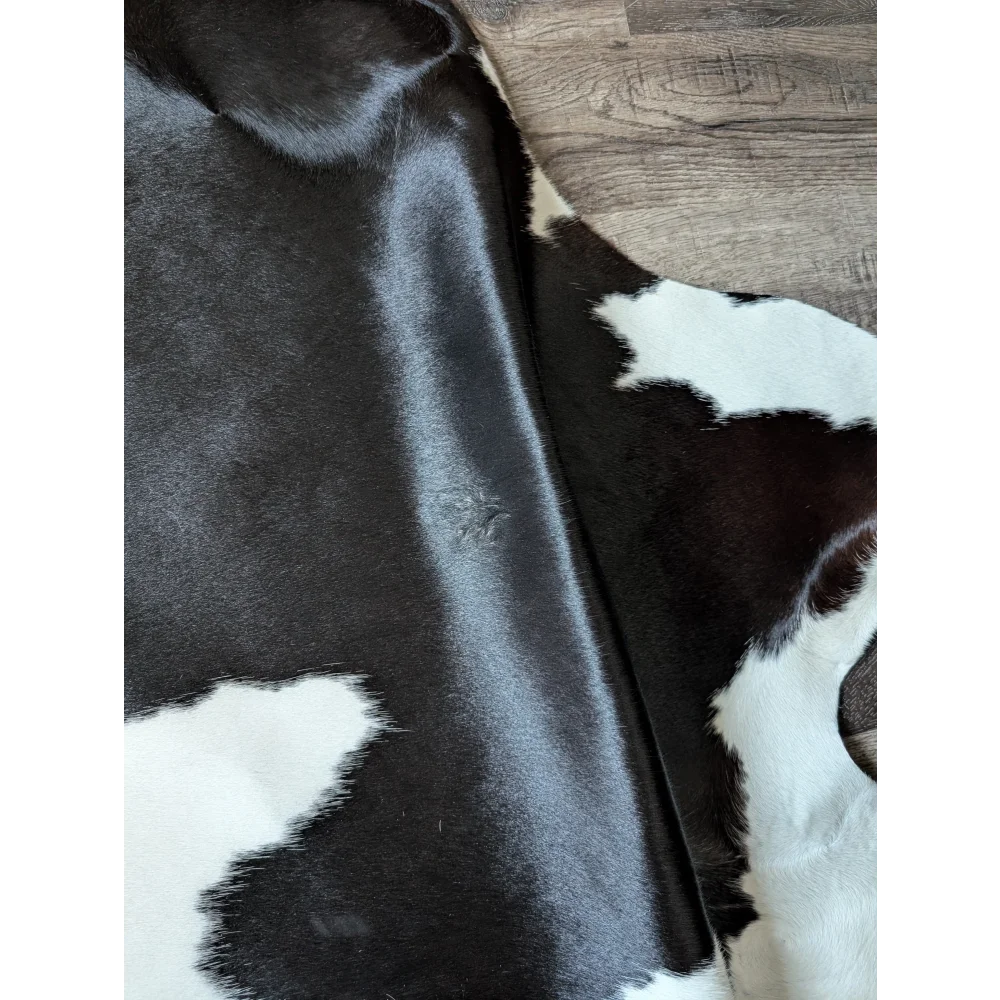 Black and white large cowhide rug with natural fur texture perfect for beautiful rugs by angus oliver