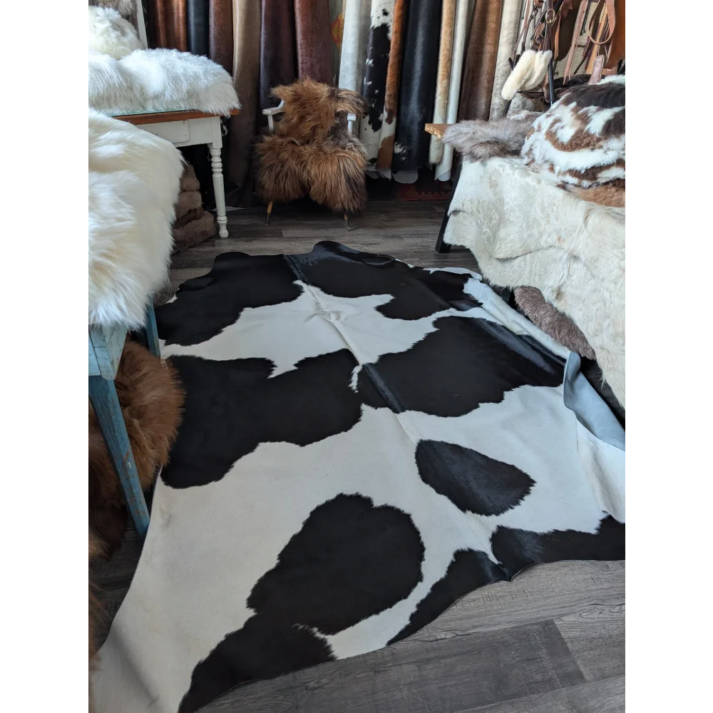 Black and white large cowhide rug with natural irregular patches from angus oliver beautiful rugs collection