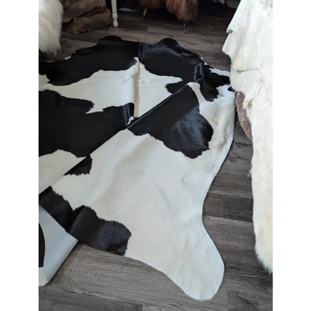Black and white large cowhide rug with natural irregular pattern from angus oliver beautiful rugs collection