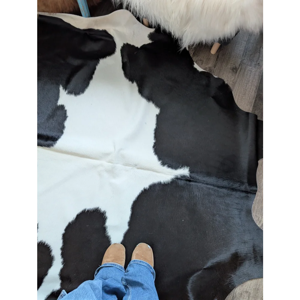 Black and white large cowhide rug with natural textured surface from angus oliver beautiful rugs collection