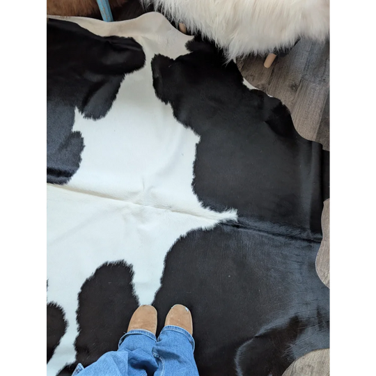 Black and white large cowhide rug with natural textured surface from angus oliver beautiful rugs collection