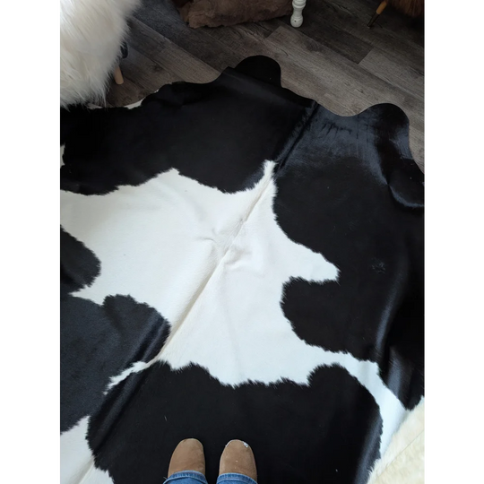 Black and white large cowhide rug with natural fur texture by angus oliver perfect for beautiful rugs collection