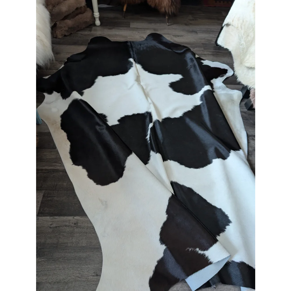 Black and white large cowhide rug with natural irregular patches by angus oliver, perfect for beautiful rugs collection