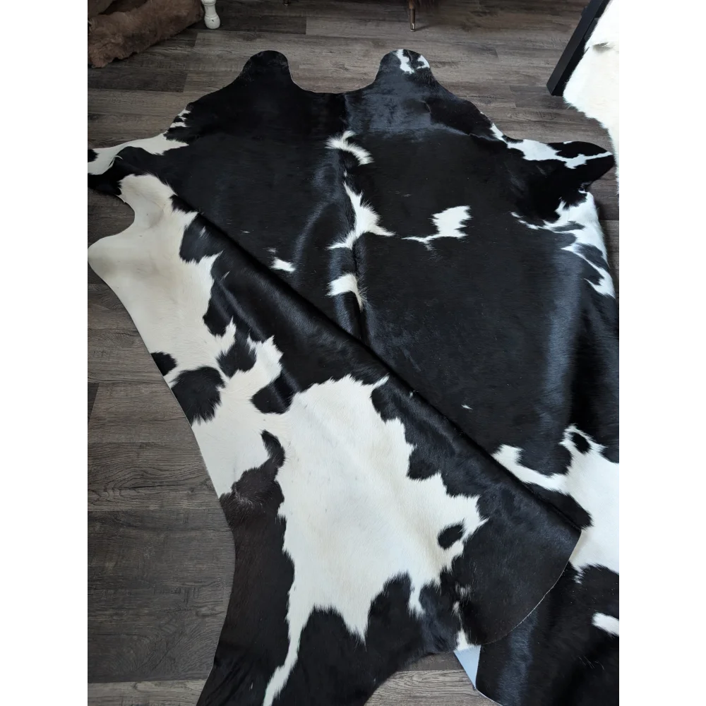 Black and white cowhide rug with natural fur texture incredibly soft underfoot angus oliver unique characteristics