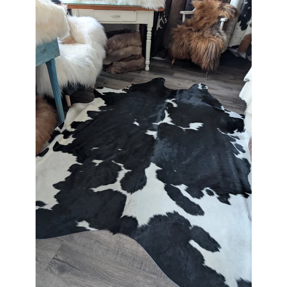 Black and white angus oliver cowhide rug with unique pattern and incredibly soft underfoot for beautiful living space