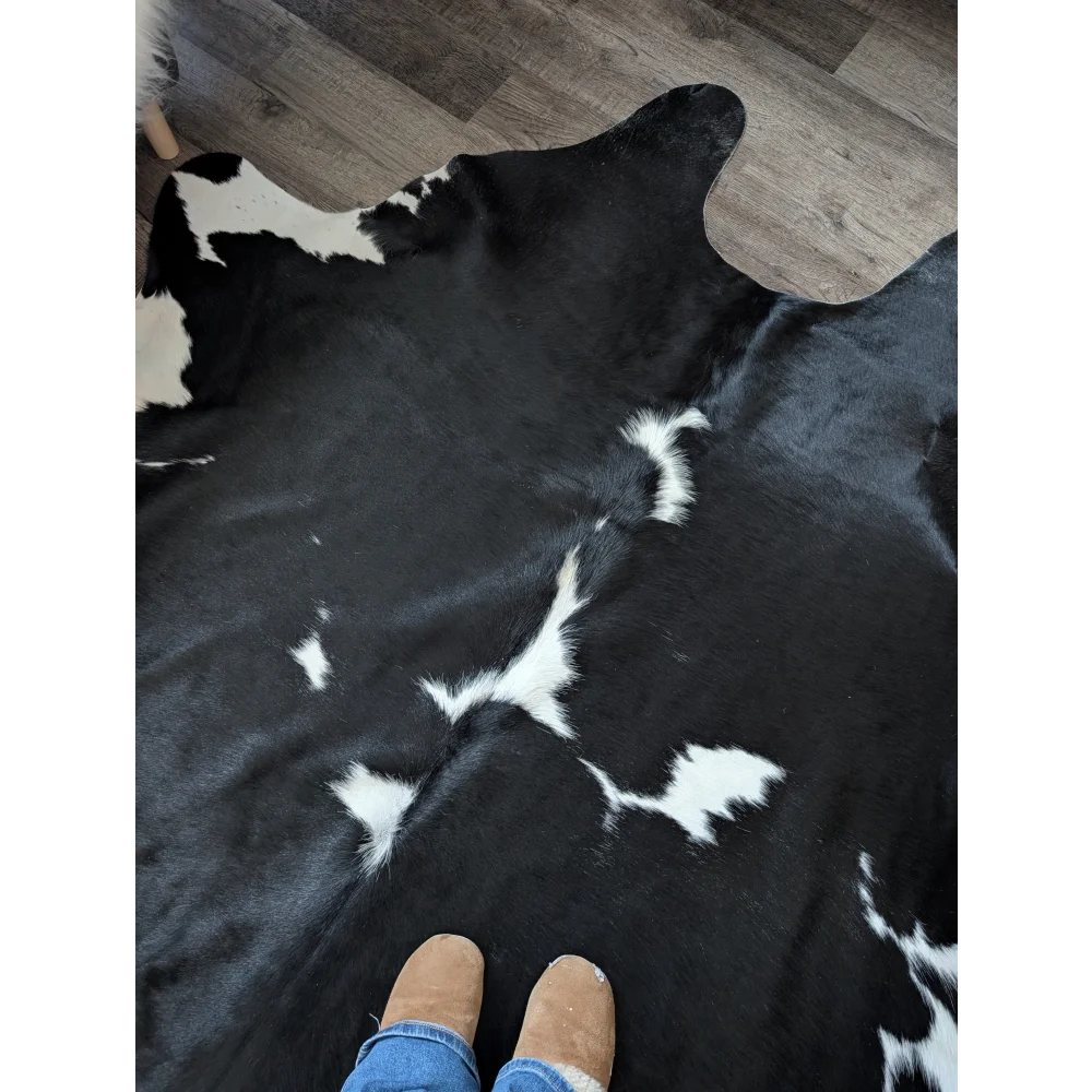 Black and white cowhide rug with natural fur texture and incredibly soft underfoot perfect for beautiful rugs for living space