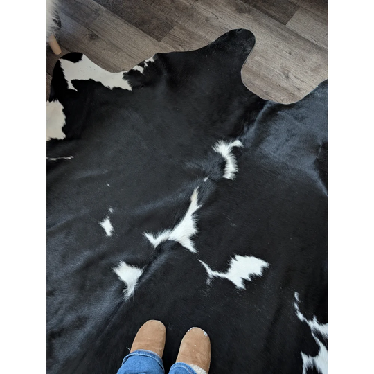 Black and white cowhide rug with natural fur texture and incredibly soft underfoot perfect for beautiful rugs for living space